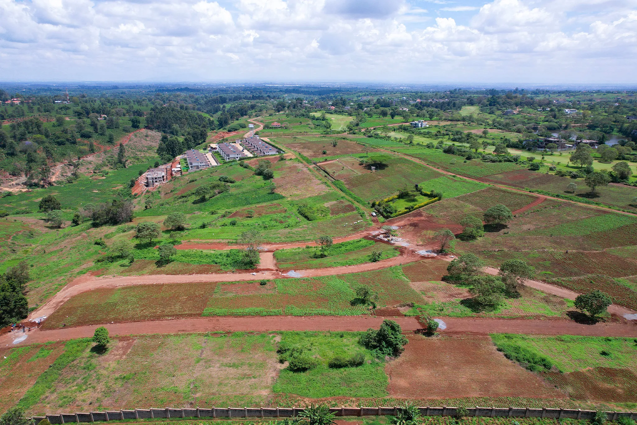 Aerial overview of Mukinduri plots with murram access roads — pre-development stage