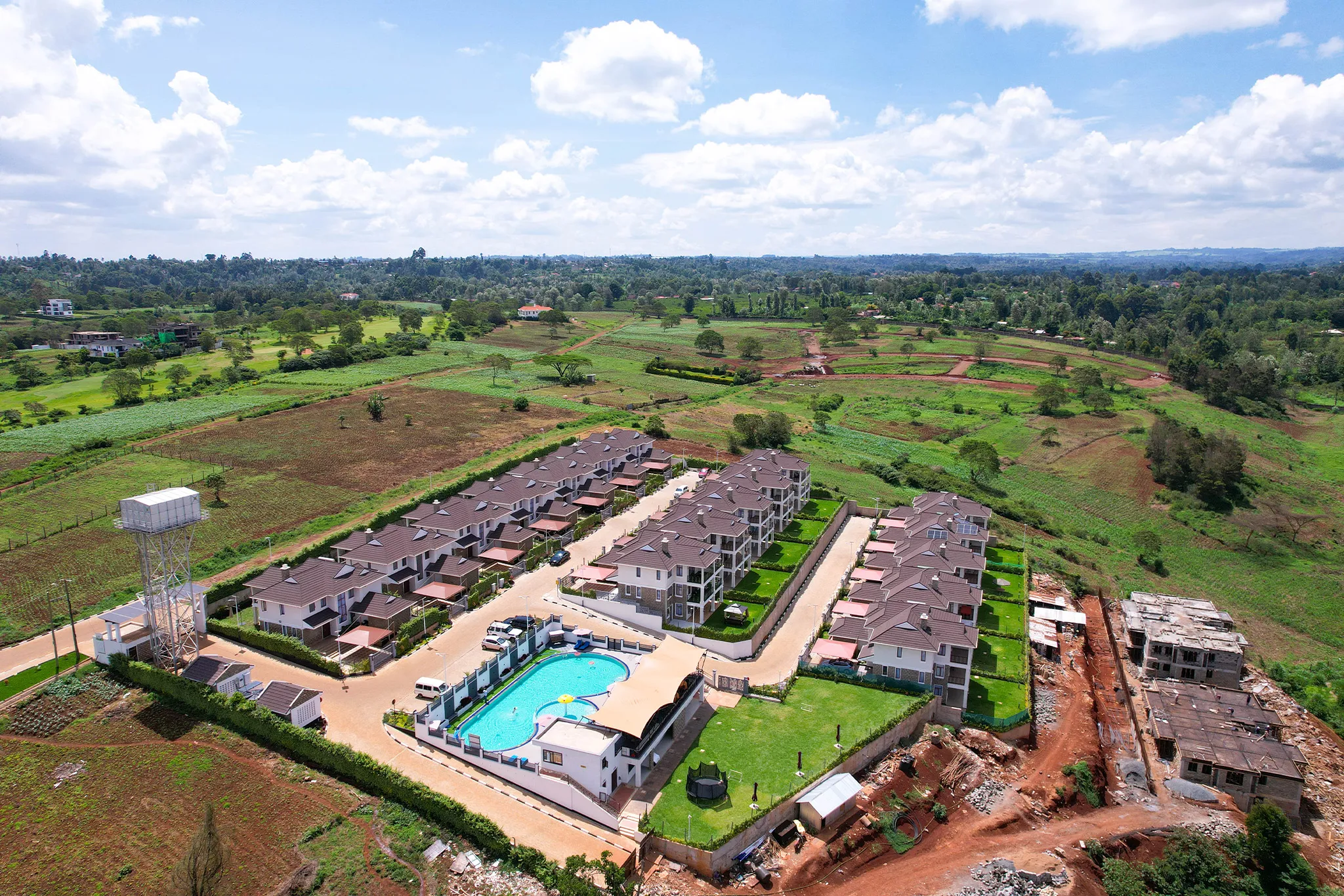 Residential cluster and pool facilities aerial view at Migaa Golf Estate